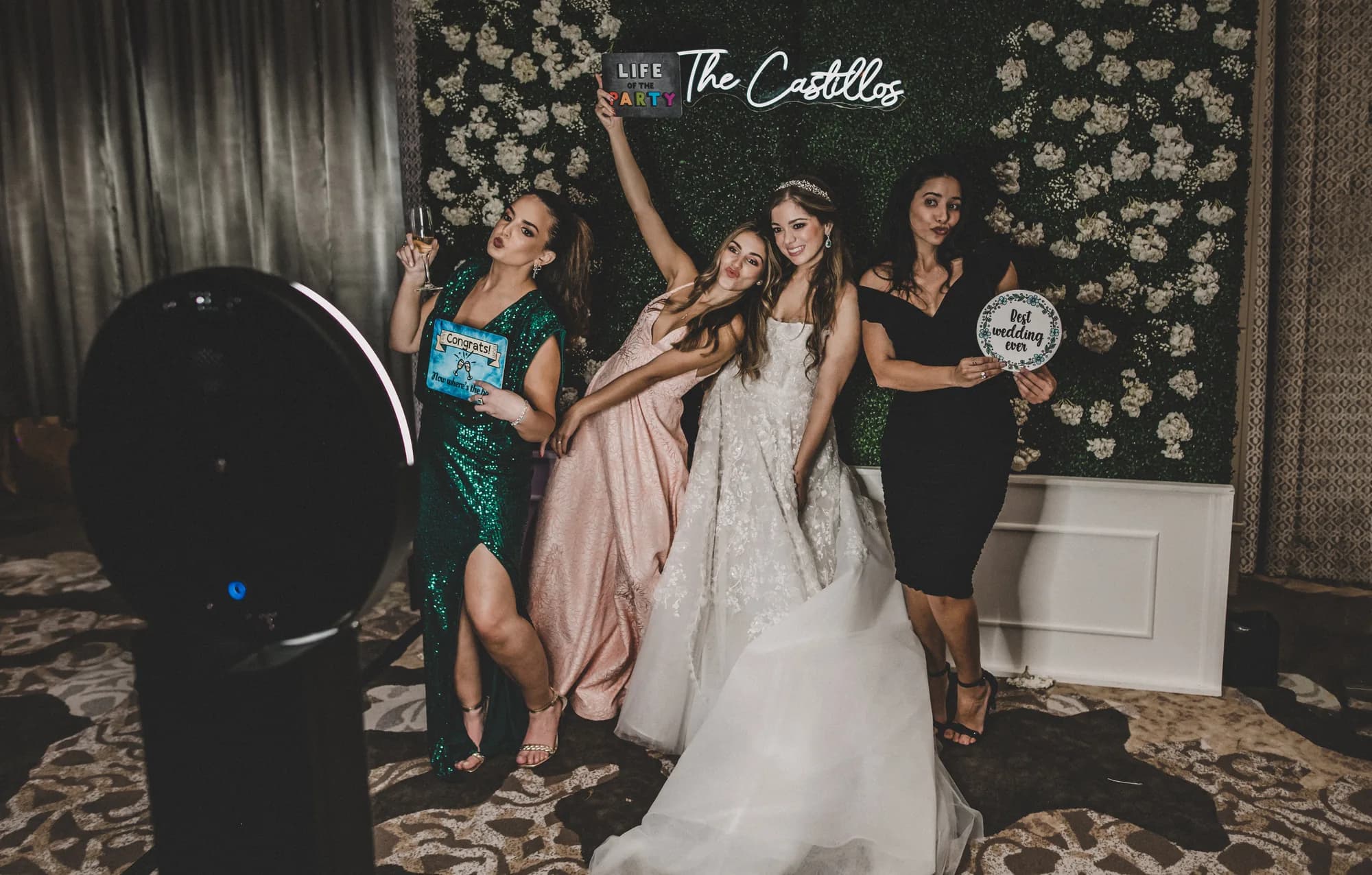 Guest on a 360 photo booth platform with LED lighting and red carpet at an Orlando event