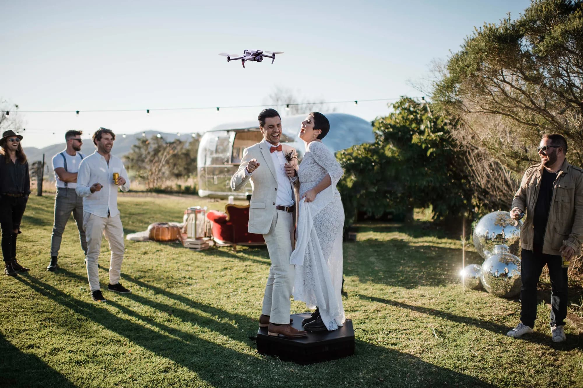 Guests using a 360 photo booth outdoors at a Central Florida wedding