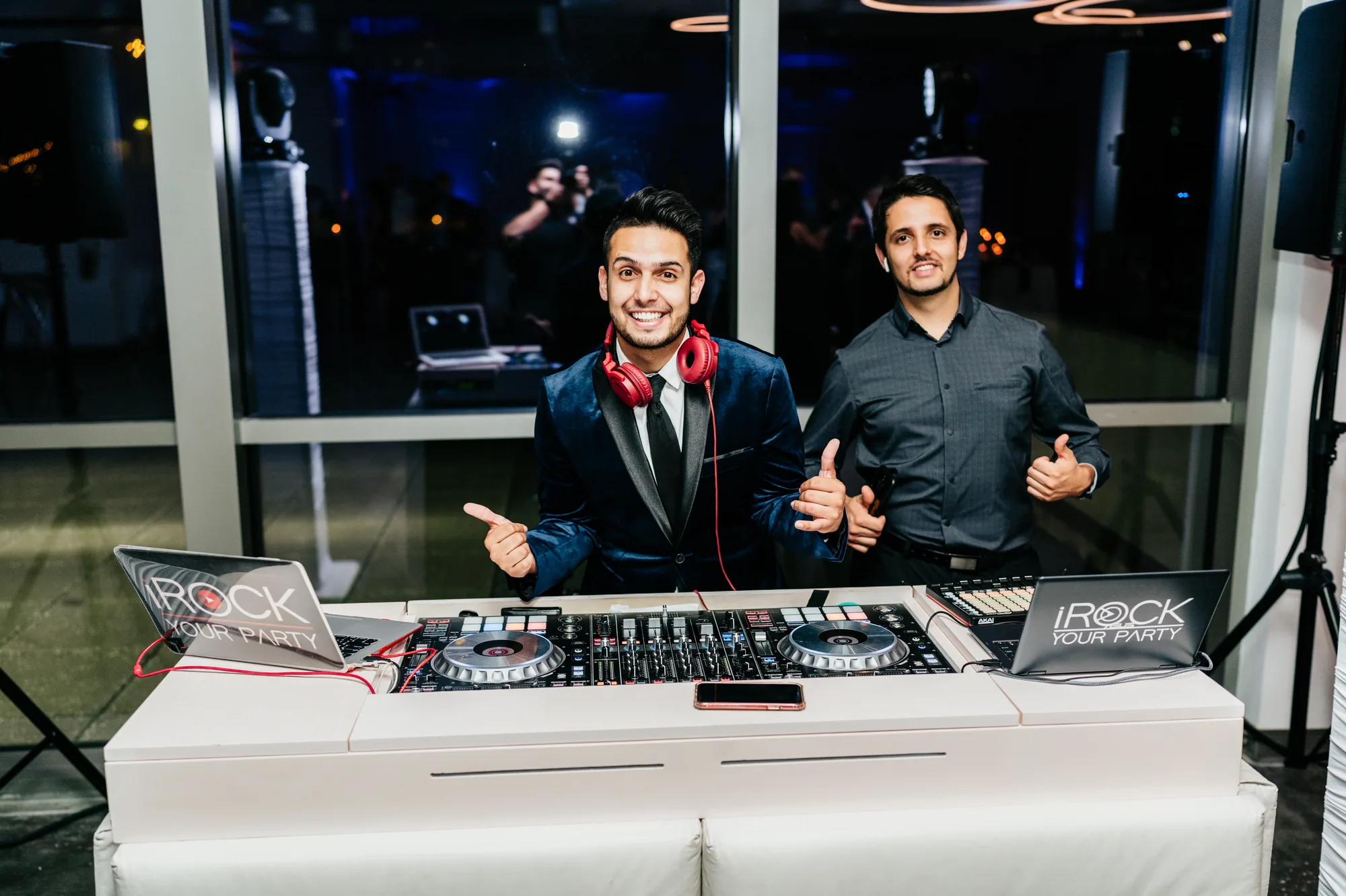 iRock Your Party DJs performing behind a lit booth at an Orlando event