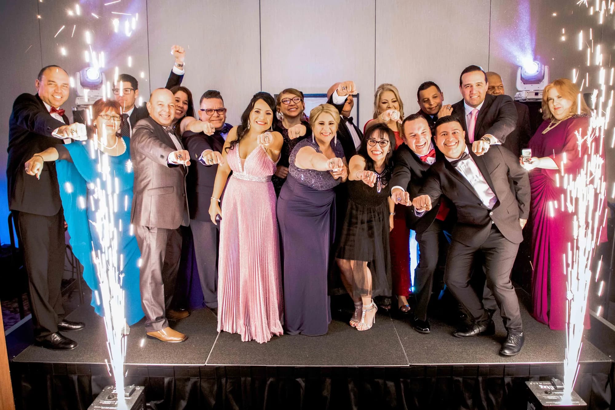 Cold spark fountains framing a group on stage at an Orlando corporate awards night