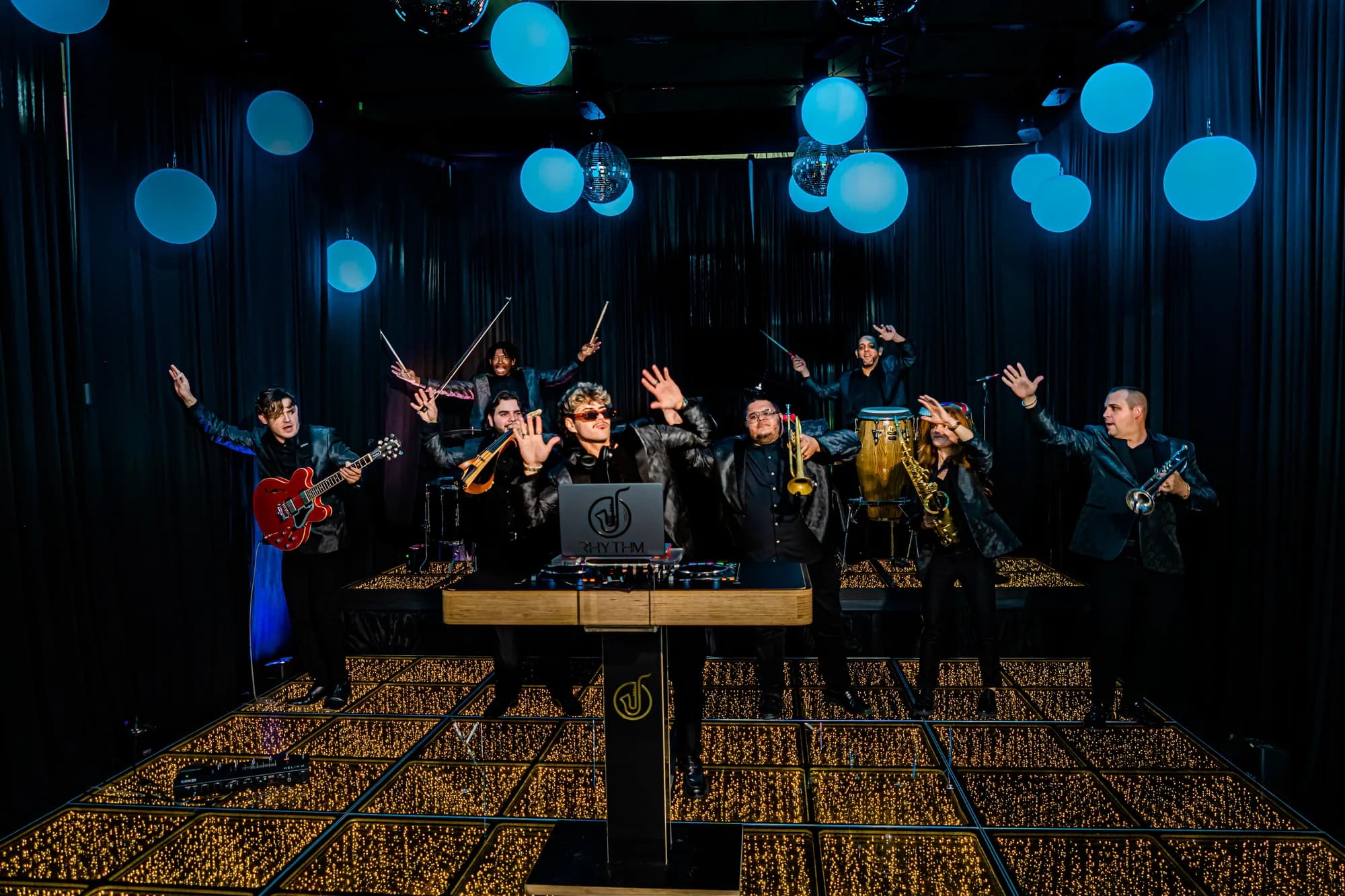 Live band performing over a gold infinity mirror dance floor at an Orlando event