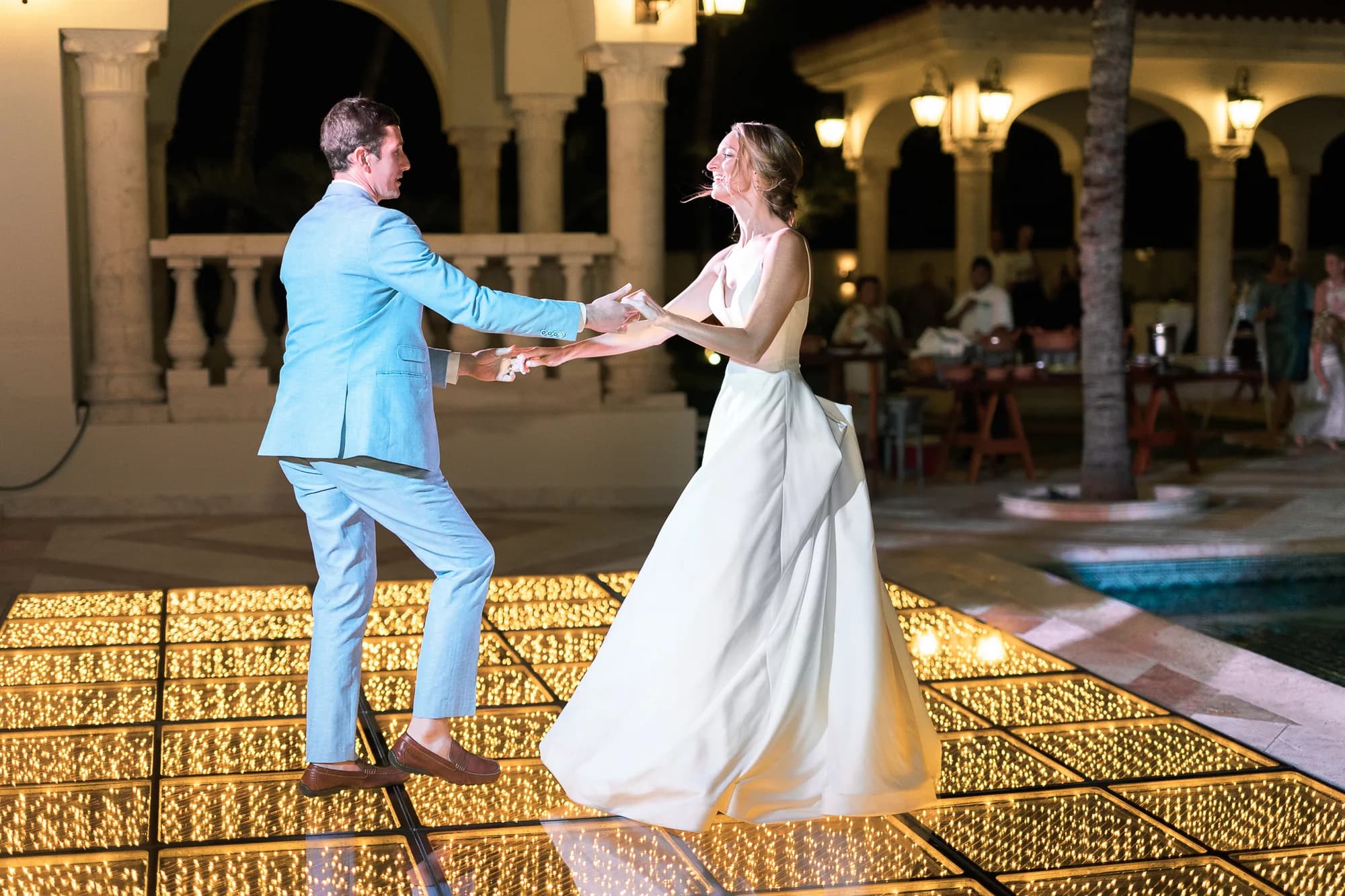 Guests dancing on a gold infinity floor at an Orlando ballroom reception