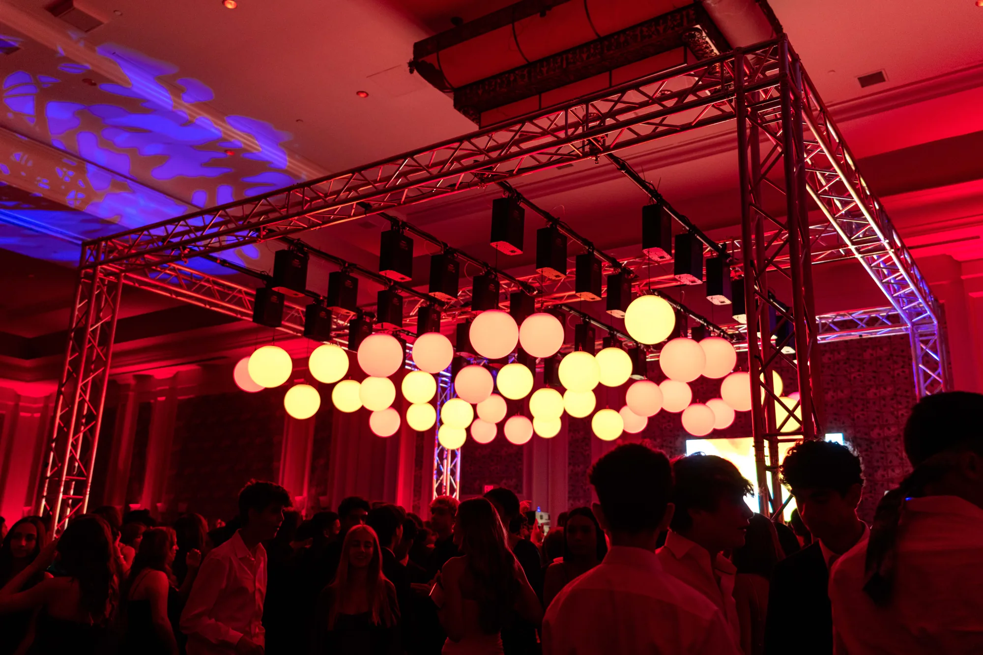 Kinetic LED spheres suspended from truss above a packed dance floor at an Orlando event