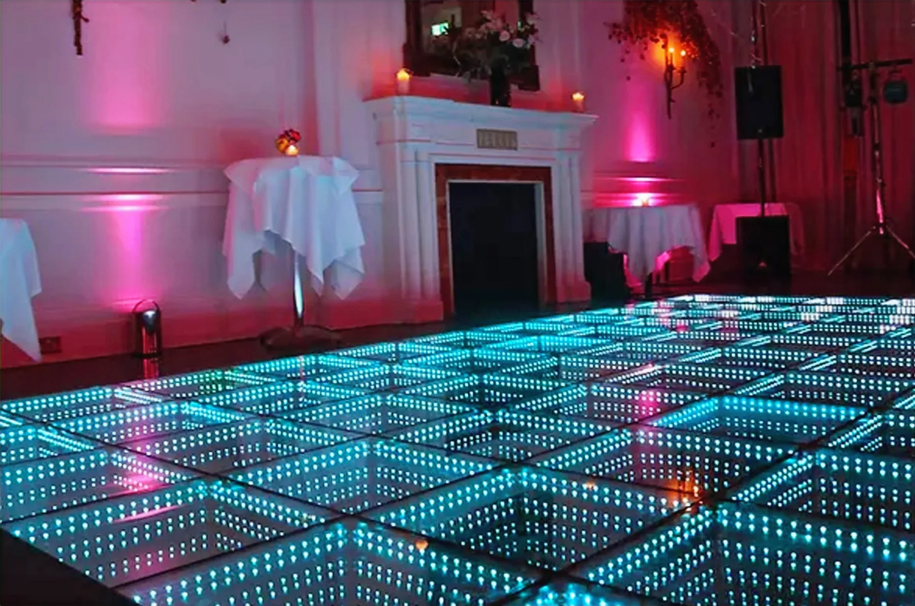 Teal LED video dance floor glowing at a Central Florida reception
