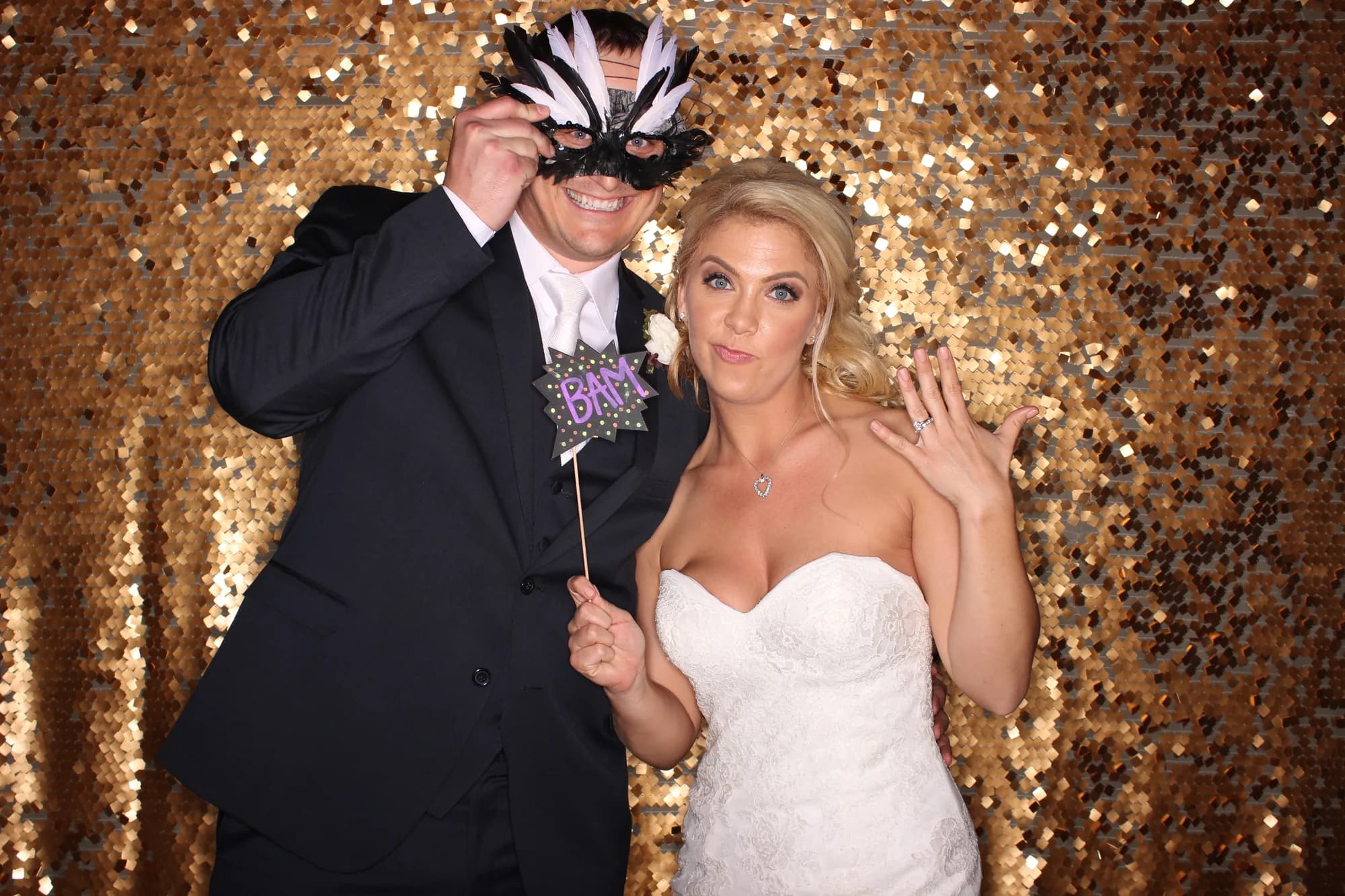 Couple photographed against a gold sequin backdrop at an Orlando event