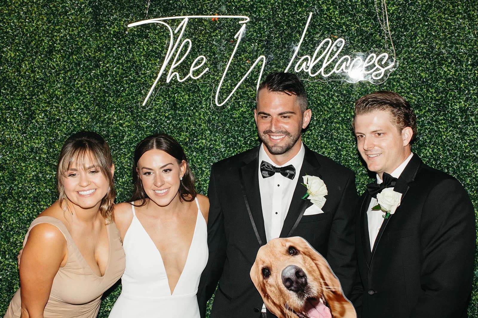 Bridal party photographed at an Orlando wedding photo booth with floral backdrop