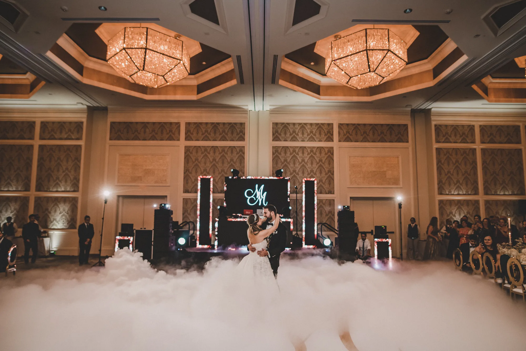 Couple dancing on a cloud effect in an Orlando ballroom with the iRock DJ booth behind them