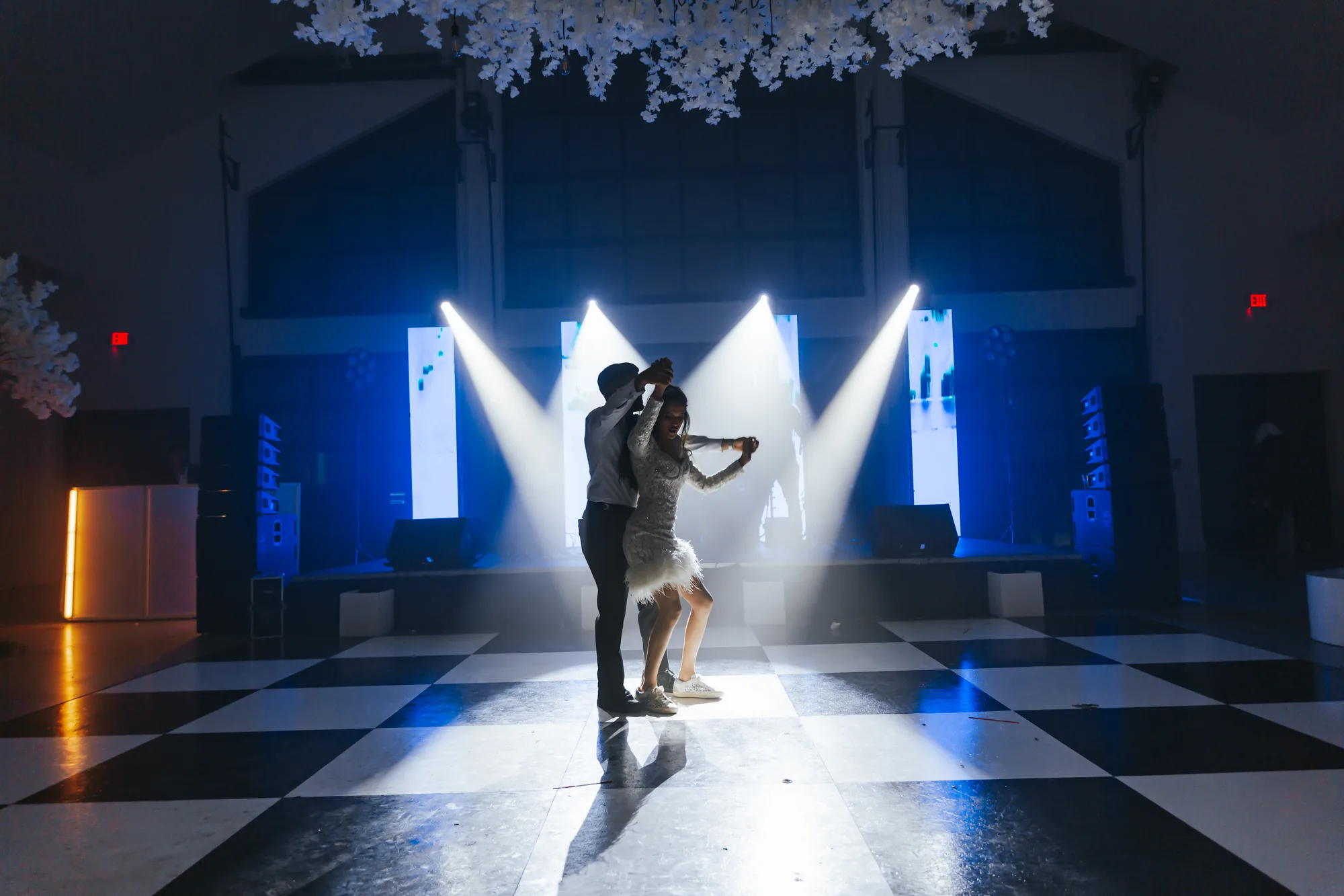 First dance under dramatic lighting on a patterned floor at an Orlando wedding