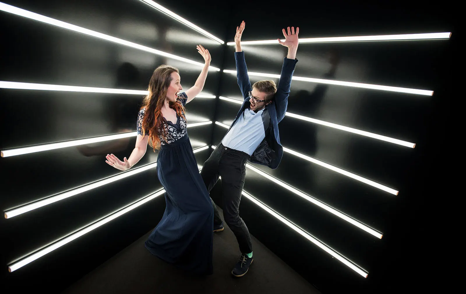 Guests jumping inside an LED light tunnel beside the 360 booth
