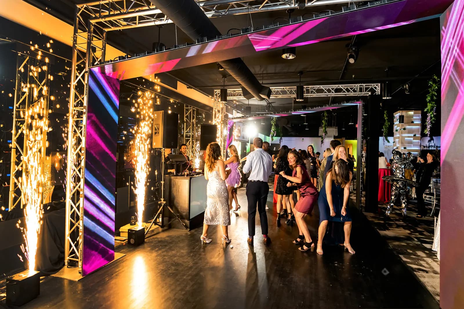 Cold sparks firing beside LED video columns at an Orlando event